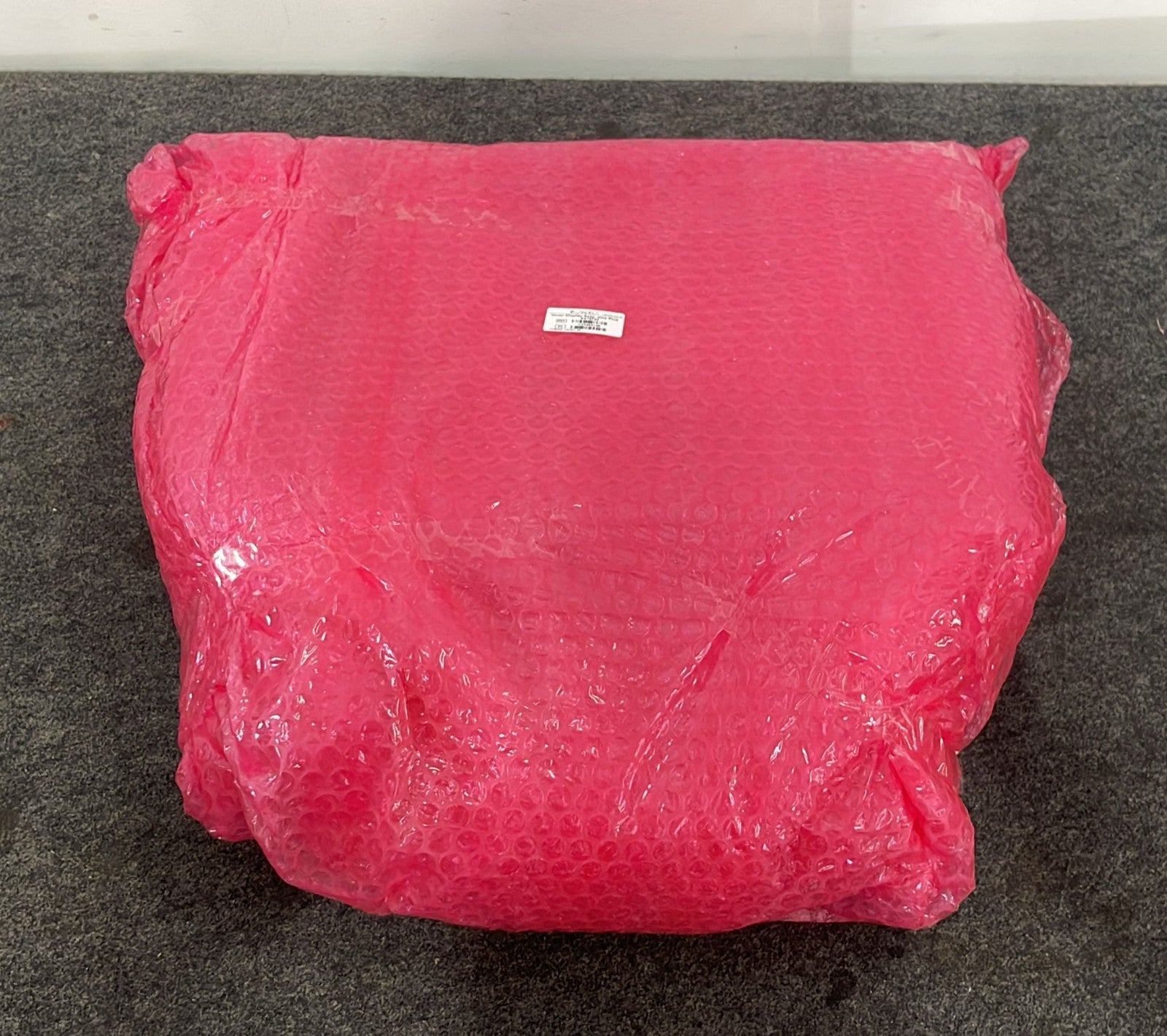Candela display assembly wrapped in protective packaging