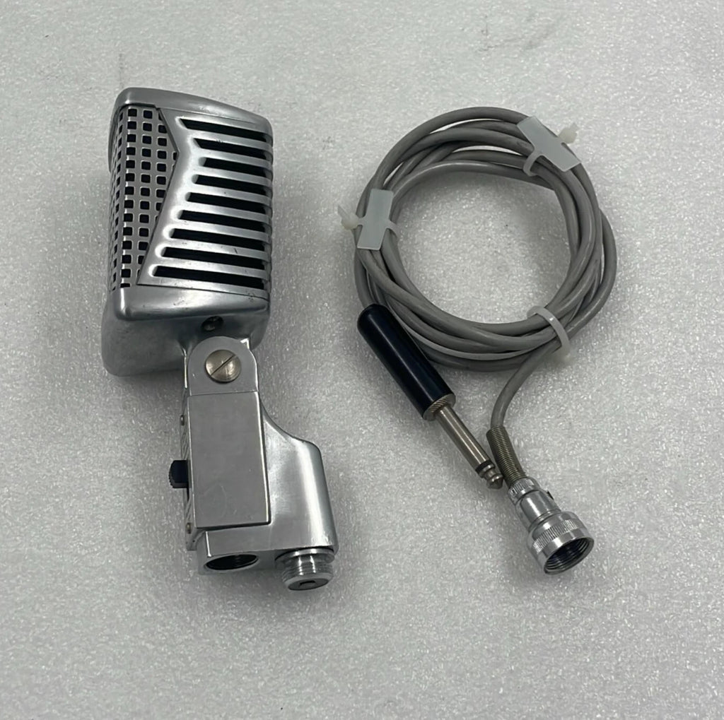 Vintage-style microphone with cable on a gray background