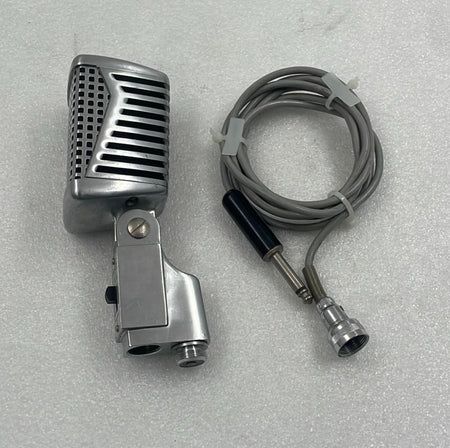 Vintage-style microphone with cable on a gray background